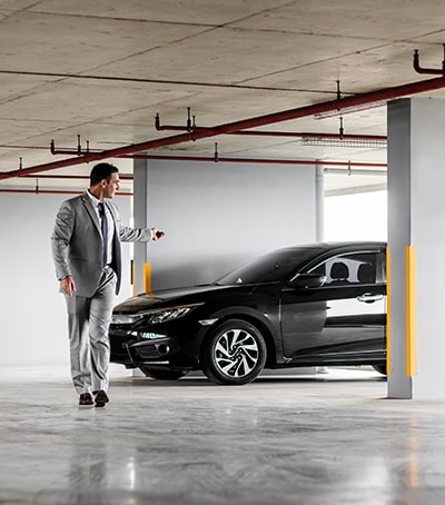 Man parking car in garage