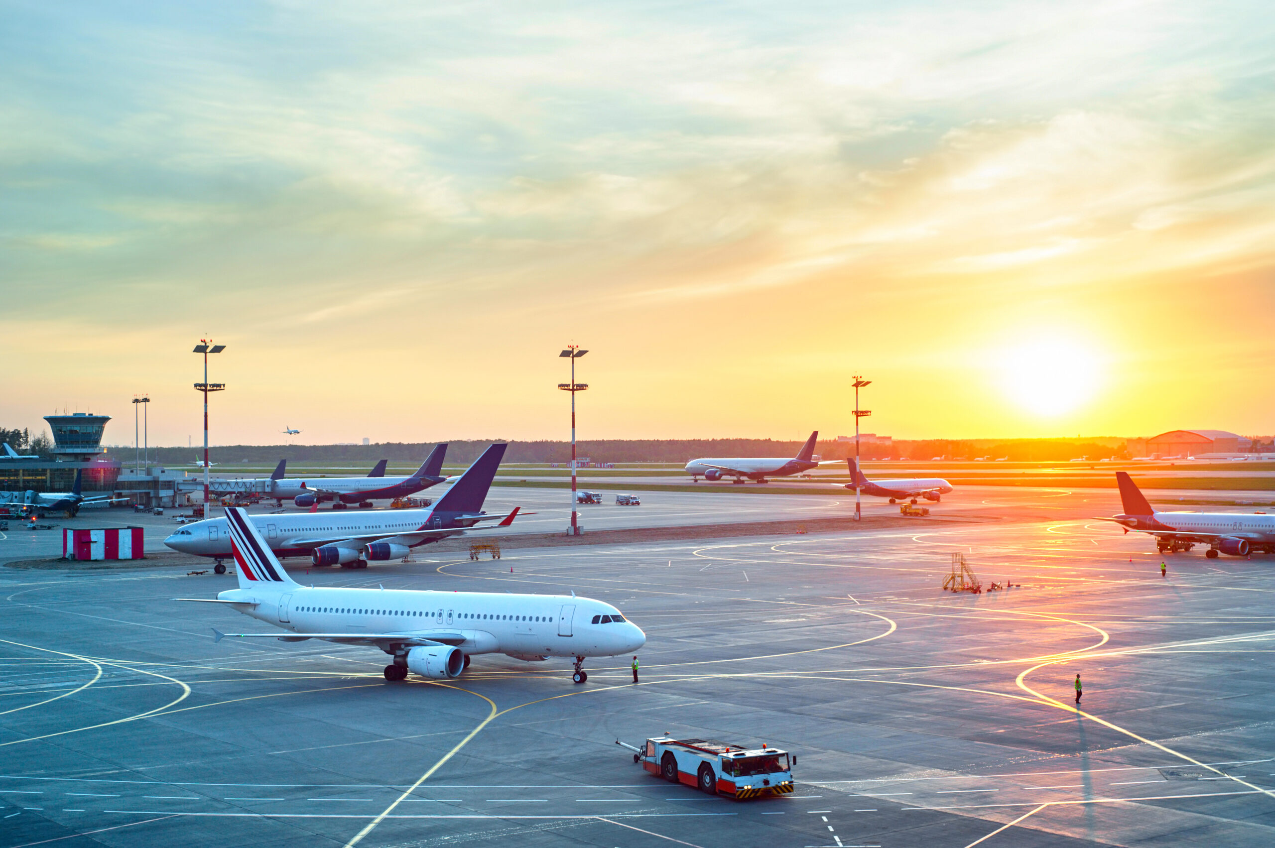 Airport with many airplanes at beautiful sunset